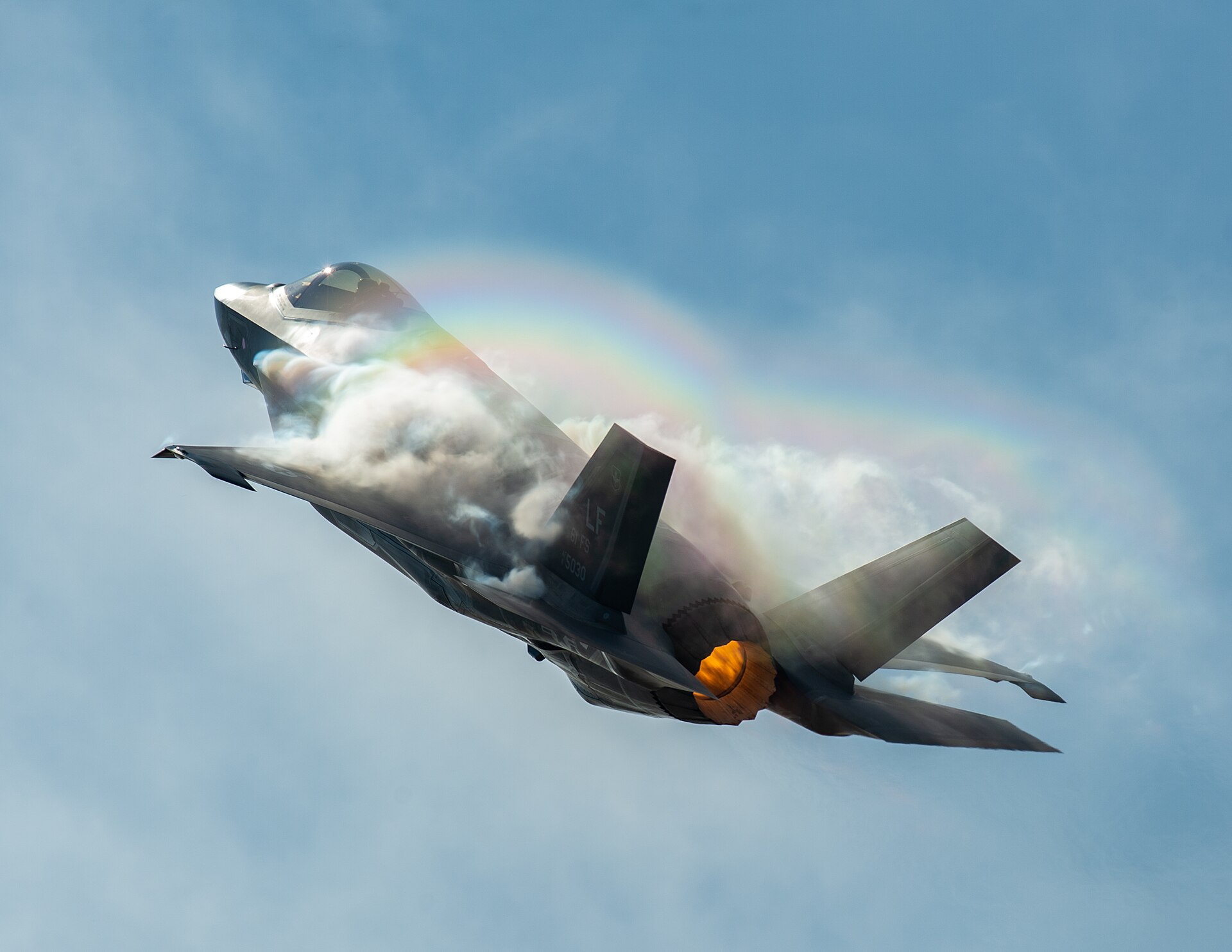 An F-35 Lightning II climbing with vapor clouds and afterburner glowing, at the Fort Worth Alliance Air Show